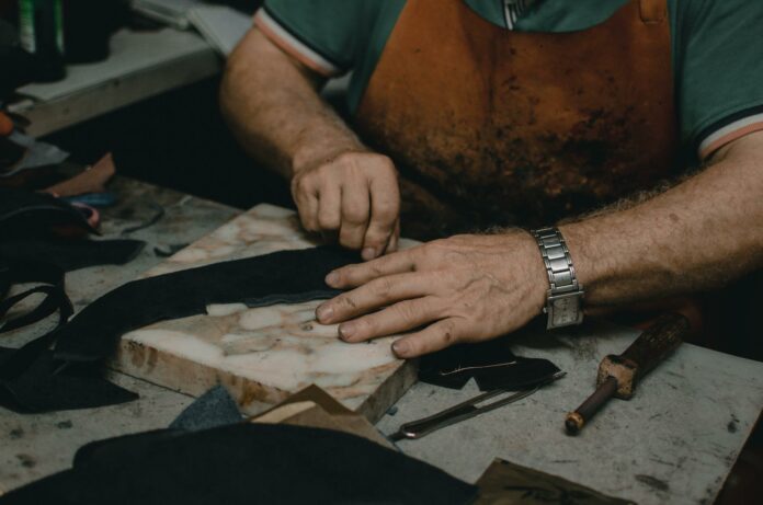 shoemaker cutting leather