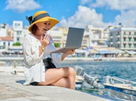 Portrait of woman in hat with laptop talking on video communication using laptop