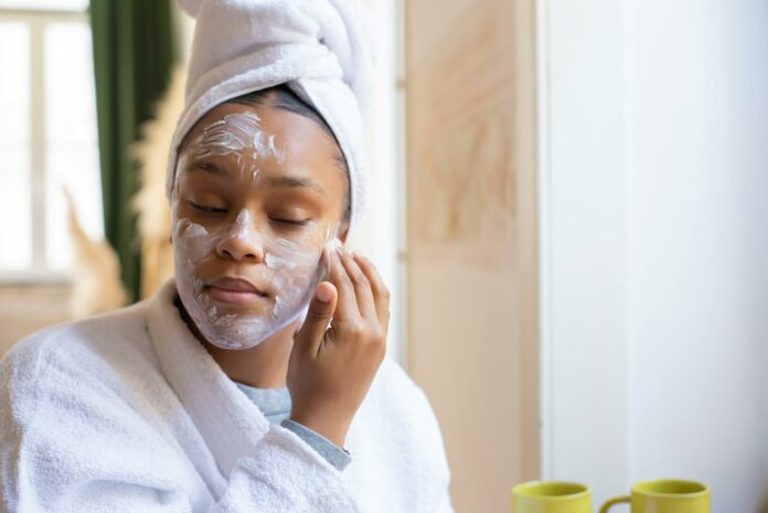 girl applying cream on her face