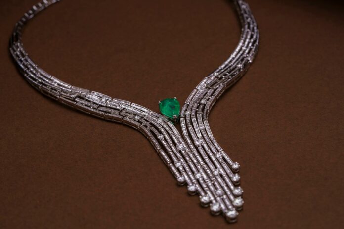 elegant diamond necklace with emerald accent