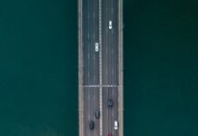 What Twenty Years of Driving to Gigs Taught Me About Travelling Cheap aerial photography of vehicles on concrete bridge