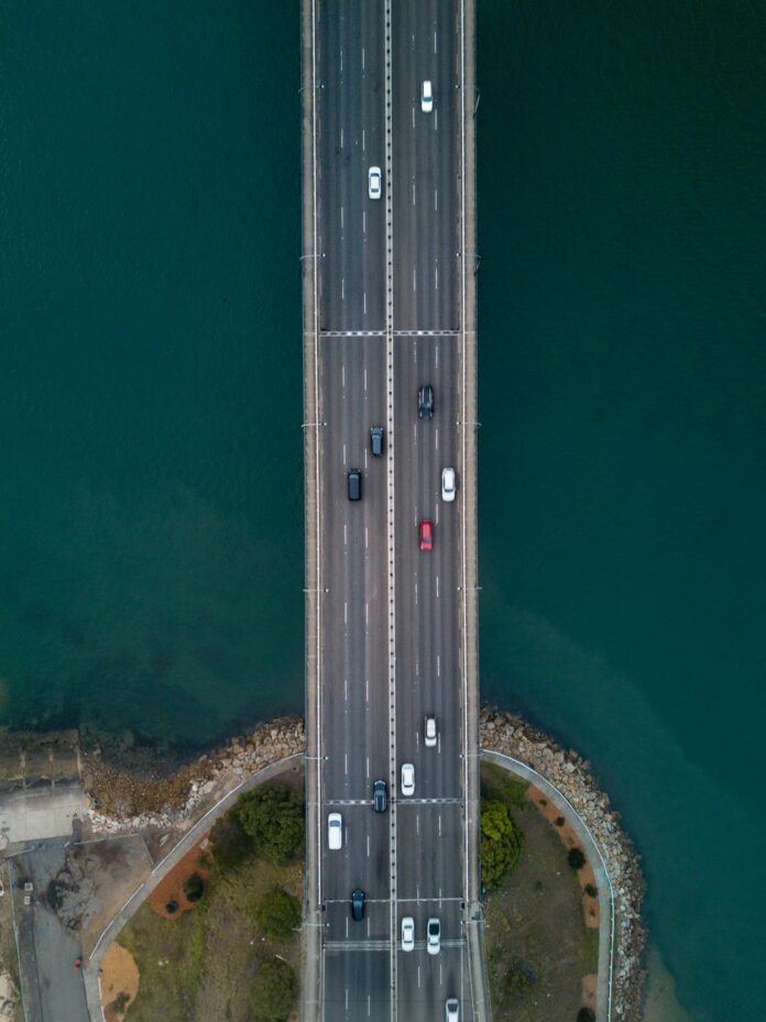 aerial photography of vehicles on concrete bridge